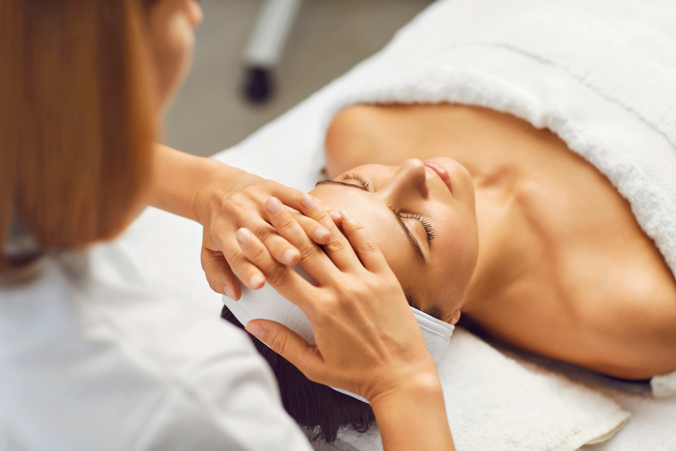 Facial Skin Beauty and Health Concept. a Woman Receives a Facial Massage from a Clinic Beautician