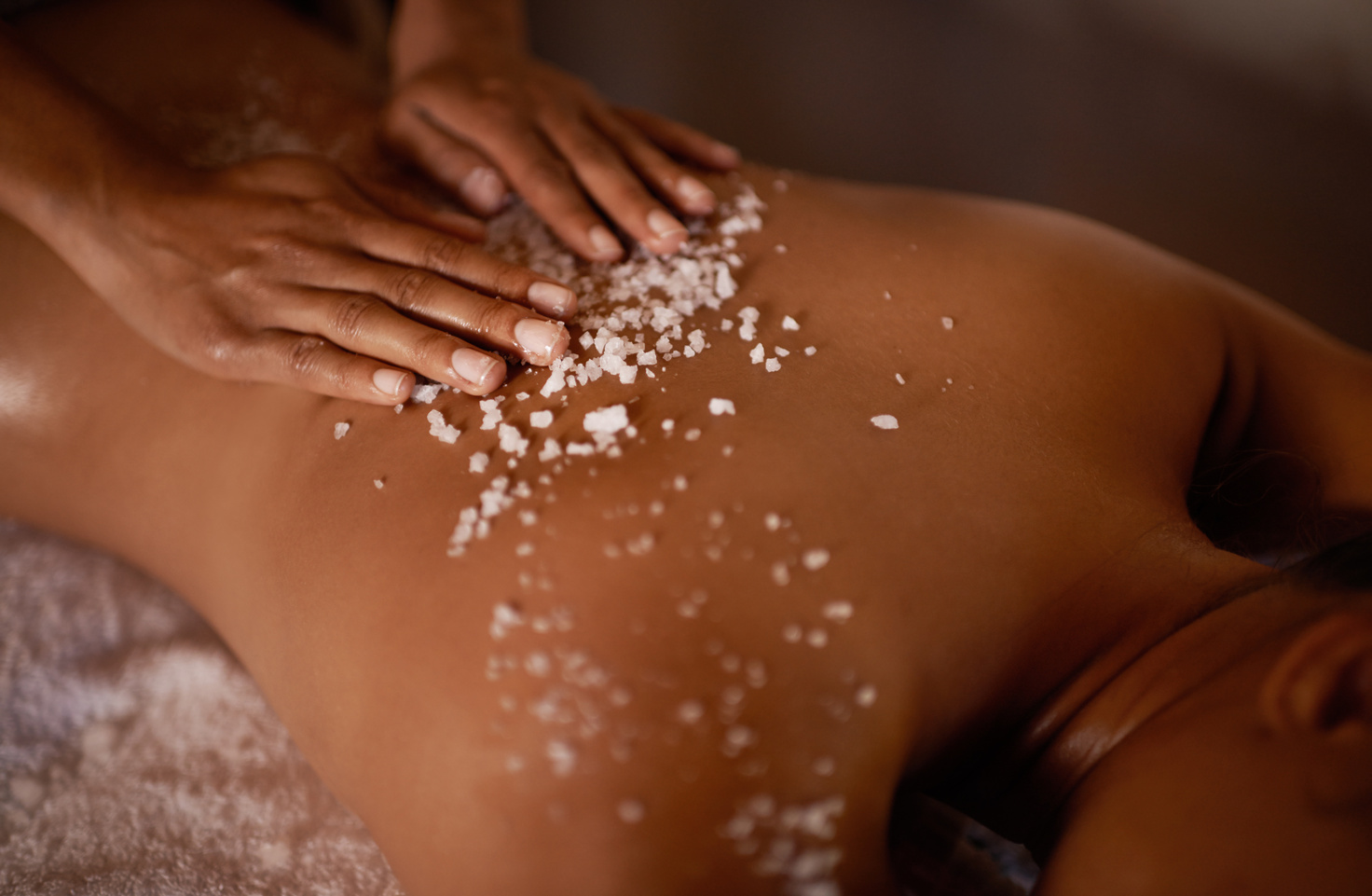 Salt, Spa Scrub and Beauty Therapist Hands with Woman Customer at a Hotel with Massage. Exfoliate , Luxury and Relax Treatment of a Female Person Back for Skincare and Wellness Exfoliation